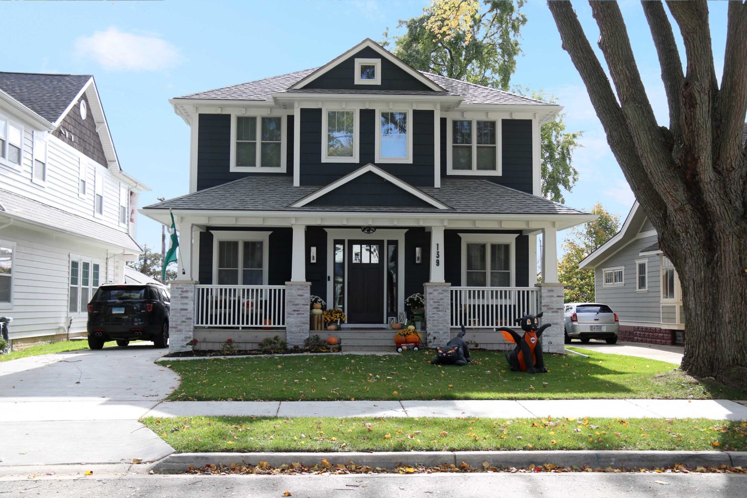 139Albertson St.- Modern two-story black house with white trim.
